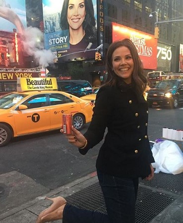 David's wife Erica Hill posing for a photo