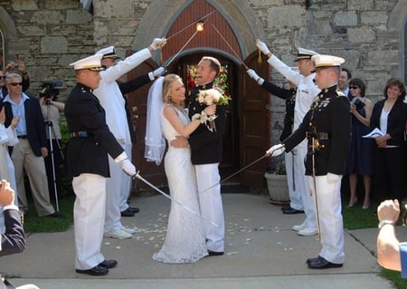 Andrea Canning and Tony Bancroft at their wedding inside the military saber arch