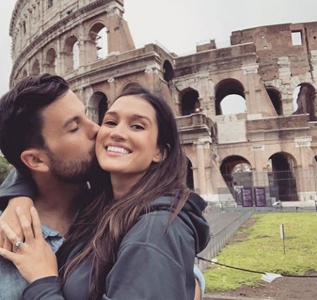 Tanner is posing with wife Jade