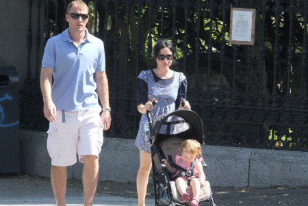 Andrea Corr and Bret Desmond with their child on the street of London