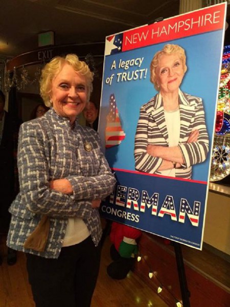 K Callan posing alongside her Congress poster