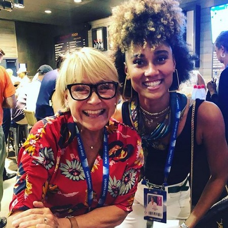 Andrea with her co-worker posing for the photo