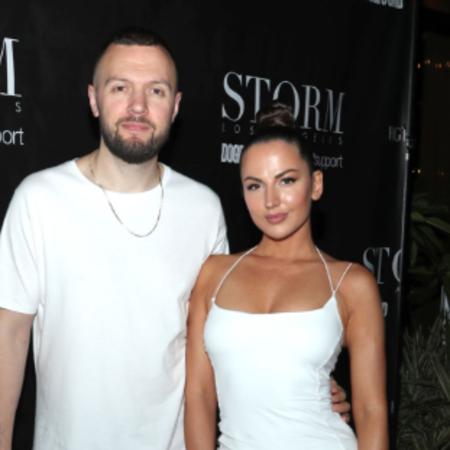 Chris and Gita walking together on black carpet