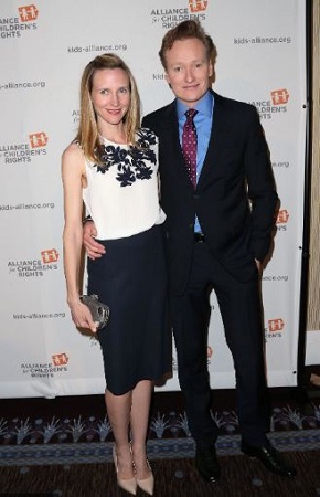 Conan attending a ceremony with his wife, Liza.