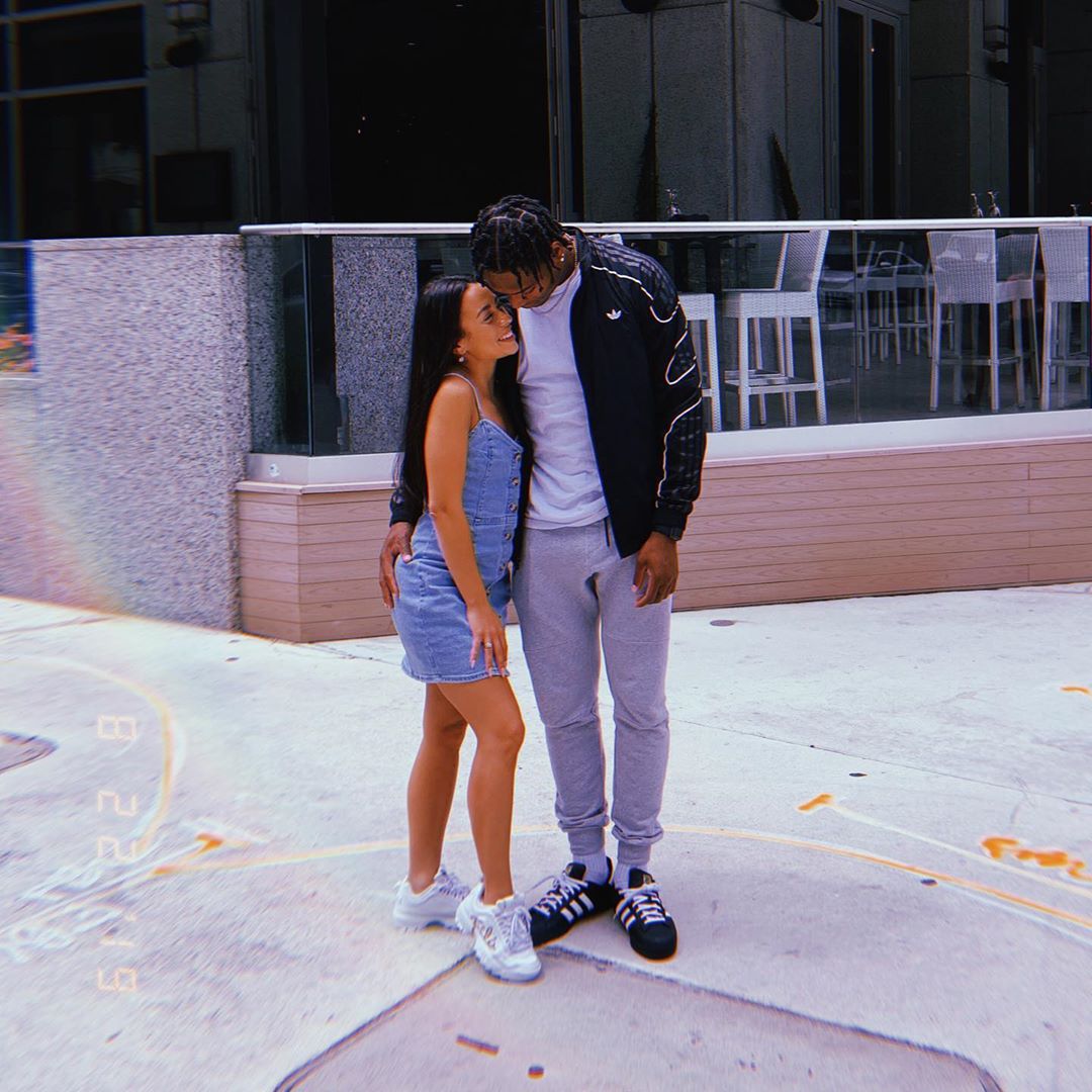 Monica in blue dress and Jalen in black bomber