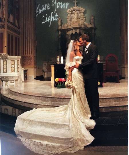 Gisele Bundchen and her spouse, Tom Brady kissing at their wedding ceremony