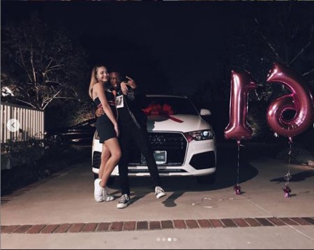 Maddie Ziegler and Kailand Morris posing with Maddie's new car during her sixteenth birthday