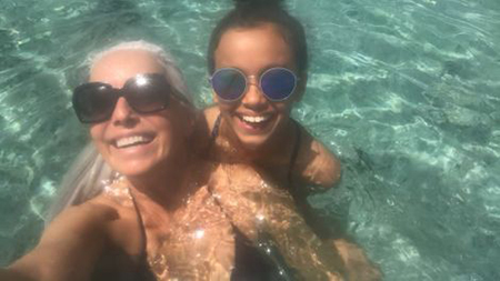 Yasmin at a beach with her granddaughter