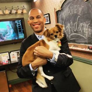 David Gura's pet dog, Ruby on the hands of Hakeem Jeffries
