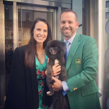 Anges Akins Garcia and Sergio Garcia with their pet dog, Bear Voyage