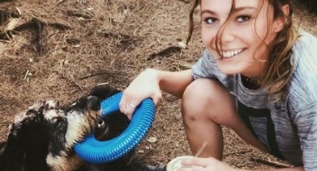 Carlie Hoffer playing with her dog