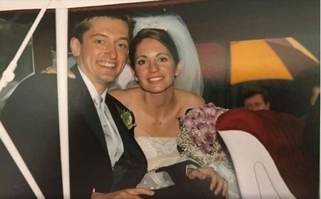 Maria and Mariusz at their wedding smiling to the camera