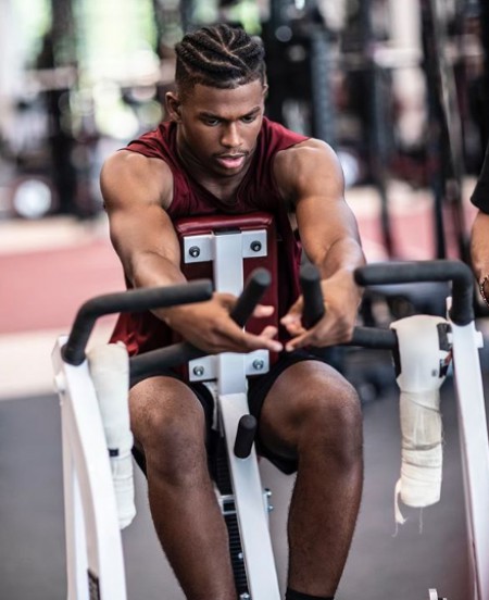 Shilo flexing muscle while in a gym. Know about his height, weight, net worth, wealth, total assets, bank balance, salary and many more