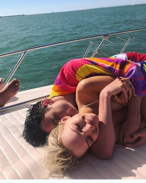 Dove Cameron cuddling her boyfriend, Thomas Doherty