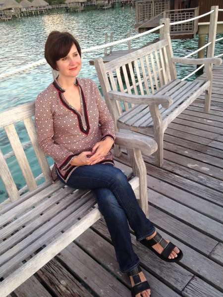 Abigail Pesta is sitting on the beach while looking the beautiful scenery