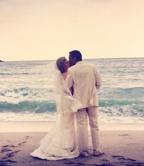 Husband, Michael and wife, Kate on their wedding day, capturing their wedding picture.