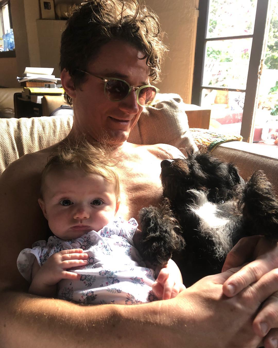 Amaryllis Fox's newly born daughter, Bobby Kennedy III in her father's arm alongside her dog