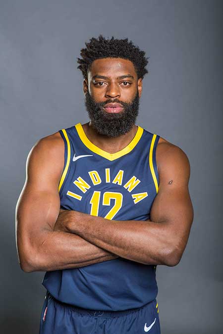 Evan is posing with his jersey.