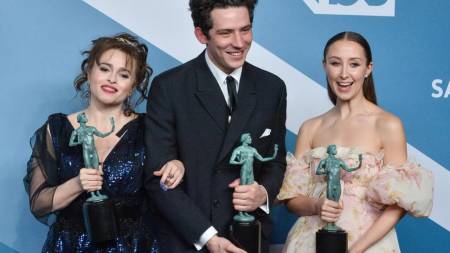 The Crown cast members holding the 2020 SAG Awards after winning in the category of best performance in an ensemble in a drama series