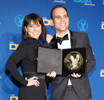 Jason holding his award in the press room with Constance Zimme