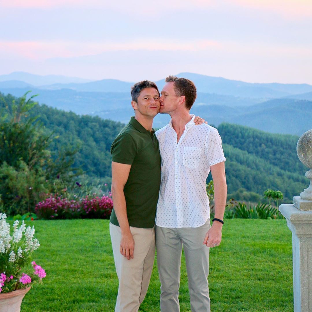 Neil kissing David on his cheek