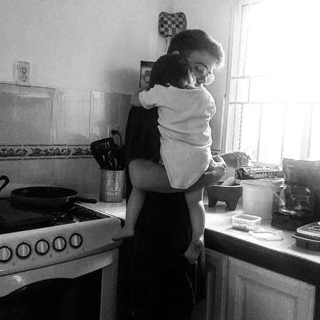 Reilly Dolman holding his baby daughter on his shoulder