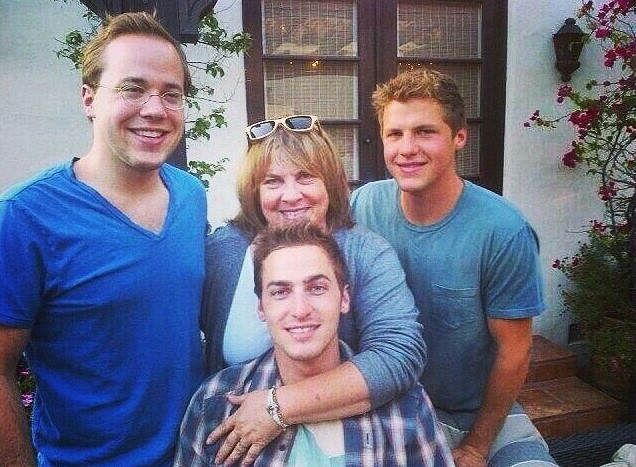 Schmidt(left) with his mother, and two brothers, enjoying a family moment.