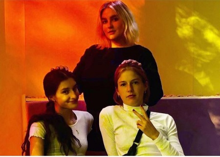 Audrey Caroline (left) pictured with her elder sisters Gracie (wearing black) and Maggie Elizabeth McGraw (right).