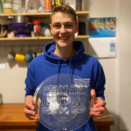 As a season 11 winner, Peter Sawkins posing with 'The Great British Bake Off' trophy