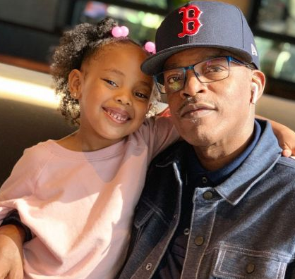 Amelia Payne's Husband Brooke Payne Holding Their Granddaughter 