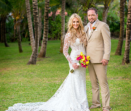 The bride and groom accompanied their wedding outfits with bright flowers