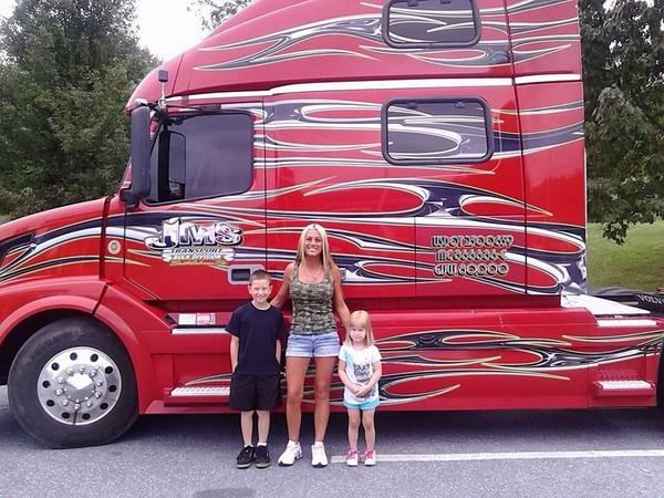 Jessica with her truck and a local fans while delivering things.