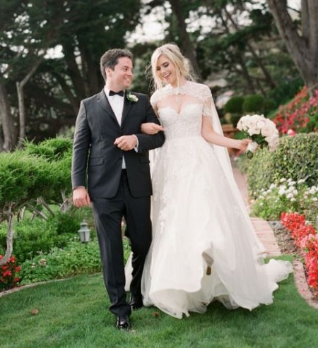 Megan Thomas Lourdes wore Odesza gown by Winnie Couture on her big day and the groom Sean Lourdes dash the look wearing a black tuxedo.