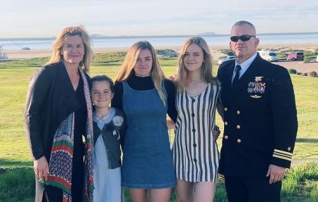 Helen and her husband with their kids.