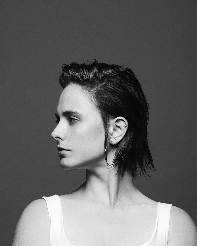 Pauline Chalamet wearing white vest looking at right side