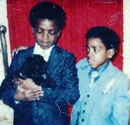 The childhood image of Calvin Hughes with his brother. Who are Hughes' parents and siblings?