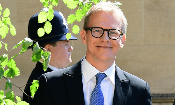 Santtu Seppälä wearing a black suit with white shirt and blue tie outside the royal wedding venue
