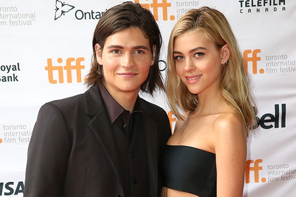 Will Peltz in his coat and Nicola Peltz in her crop top