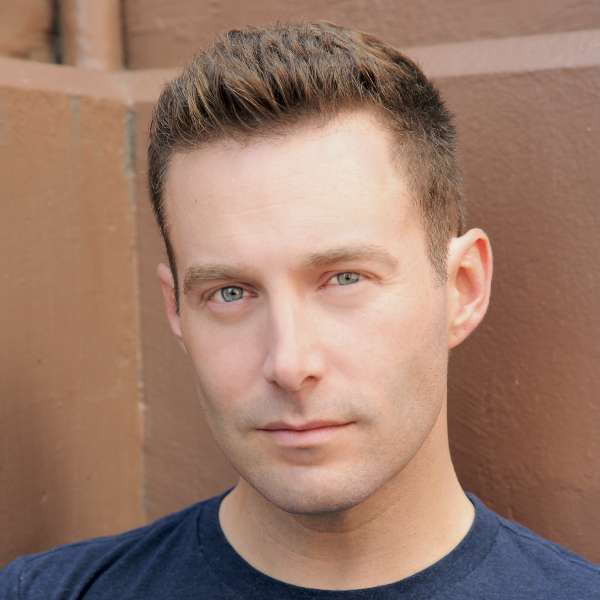 Photo of Sam Boxleitner wearing a black t-shirt.