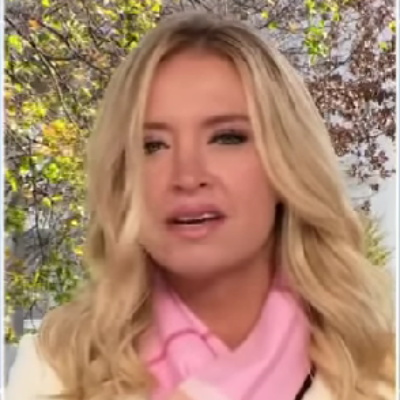 She is seen wearing a pink scarf in the picture.