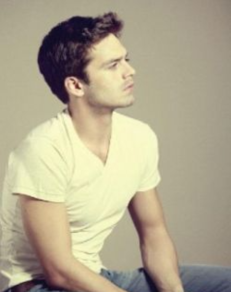 Photo of Cappy Van Dien in blue pants and a white t-shirt. I