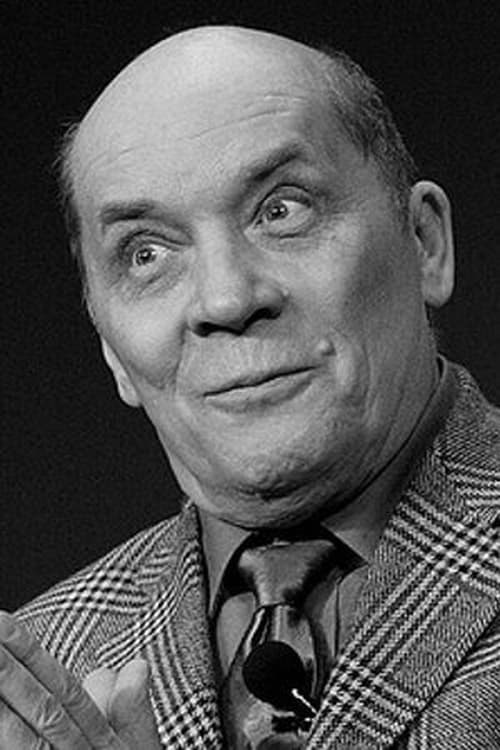 Black and white Photo of Aleksandr Filippenko wearing a coat, shirt and tie.