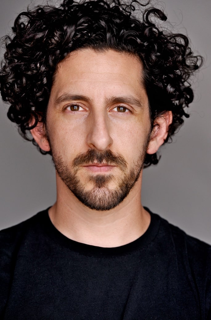 Photo of Adam Shapiro wearing a black t-shirt.