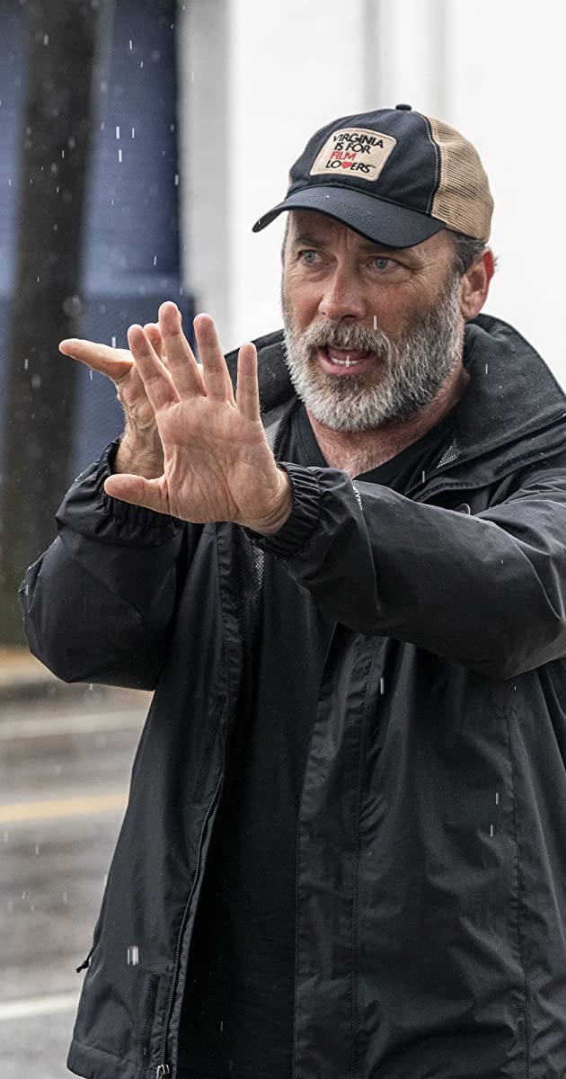 Photo of Derrick Borte wearing a black jacket and cap.