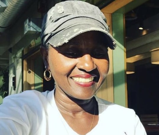 photo of Darlene Mowry wearing a cap and a white t-shirt.