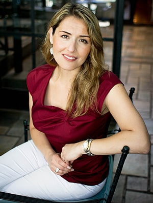Jenny Perez Schmidt posing by sitting in a chair.