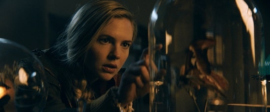 Caitlin Custer in a black jacket in The Mortuary Collection.