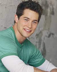 Photo of Jason Gerhardt wearing a green & white t-shirt.