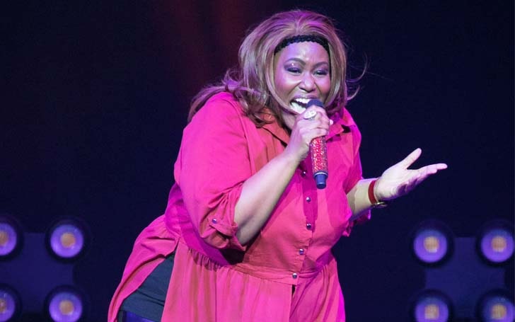 Mandisa Glover wearing red and speaking in a mike