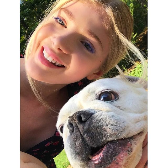 Elena taking picture with her pet 